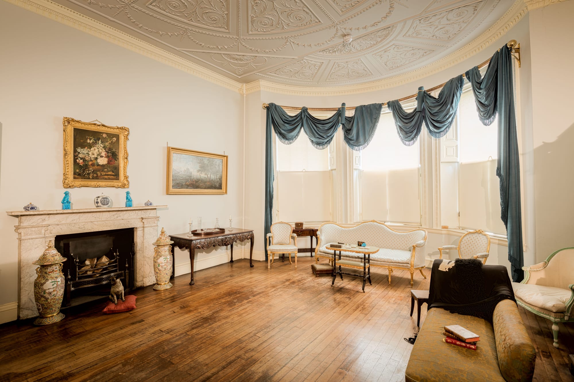 Georgian drawing room with a decorative plaster ceiling, marble fireplace and bay of sash windows